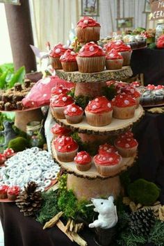 cupcakes are stacked on top of each other in the shape of trees and mushrooms