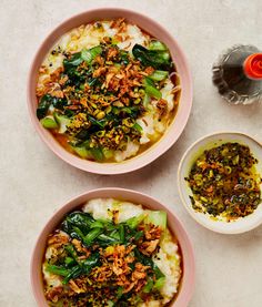 three bowls filled with food on top of a white table next to an empty bowl