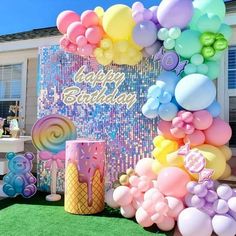 an outdoor birthday party with balloons and decorations