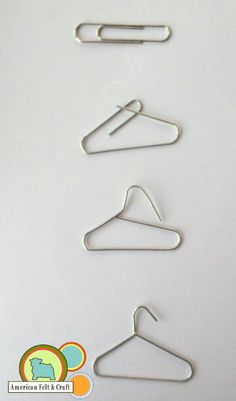 three pairs of metal clothes hangers on a white surface