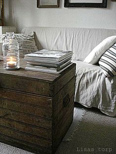 a living room filled with furniture and pictures on the wall