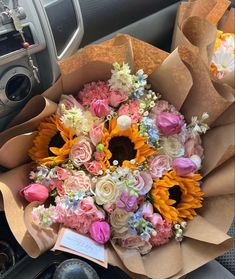 a bouquet of flowers sitting in the passenger seat of a car