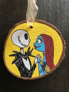 a wooden ornament with a skeleton and jack skellingy face on it