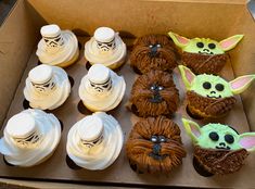 star wars themed cupcakes in a box with the faces of yoda and baby yoda