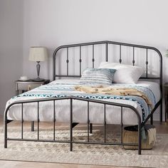 a bedroom with a metal bed frame and white walls