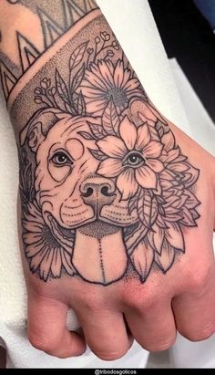 a hand with a dog's face and flowers on it