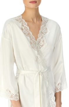 This silky satin robe takes a romantic turn with sheer scalloped lace tracing the front and sleeves. 36" length (size Medium). Ties at waist. Three-quarter sleeves. 100% polyester. Machine wash cold, tumble dry low. By Lauren Ralph Lauren; imported. Lingerie. Elegant Long Sleeve Lace Sleepwear, V-neck Robe With Lace Trim For Wedding Night, Feminine Fitted Robe With Lace Trim, Fitted Feminine Robe With Lace Trim, Lace Robe With Lace Trim For Sleep, Lace Sleep Robe With Lace Trim, Lace Trim Sleep Robe, Fitted Satin Robe With Lace Trim, Long Sleeve Satin Robe With Lace Trim