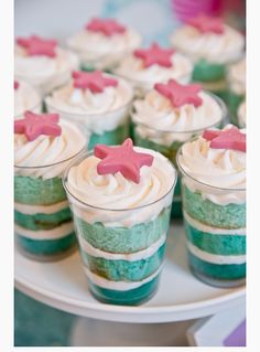 cupcakes with pink stars and green frosting on a plate