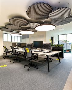 an office with multiple desks and computers