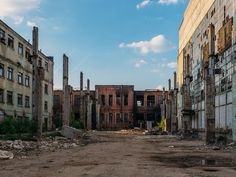 an old run down city street with lots of windows and crumbling buildings on both sides