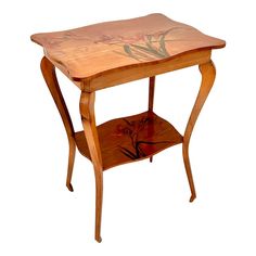 a small wooden table with an artistic design on it's top and bottom shelf