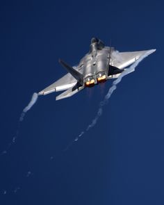 a fighter jet is flying through the air