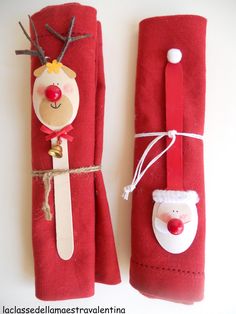 two red napkins decorated with santa claus and reindeer faces