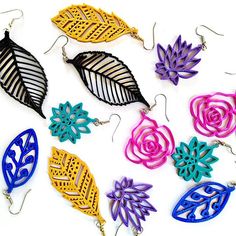 several pairs of earrings with different colors and designs on them, all in the same pattern