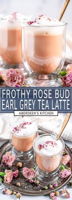 three small cups filled with tea on top of a tray next to flowers and spoons