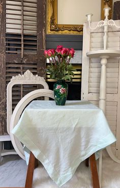 a vase with flowers on top of a table