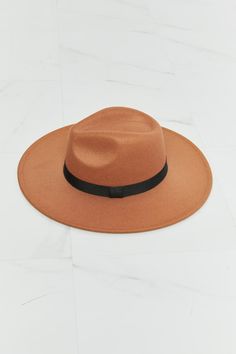 Made from high-quality materials, this fedora hat is durable, comfortable, and designed to fit most head sizes. The tan-colored hat features a classic fedora style with a black ribbon band that adds a chic and elegant touch to itsgenerallook. The ribbon detailing is perfectly placed to create a flattering shape for the hat that enhances its style andgeneralaesthetics. The adjustable straps on the inside of the hat ensure a comfortable and secure fit for any head size, making it perfect for all-d Fedora Pattern, Fedora Style, Elegante Y Chic, Chic And Elegant, Simple Things, Affordable Jewelry, Black Ribbon, Fedora Hat, Tan Color