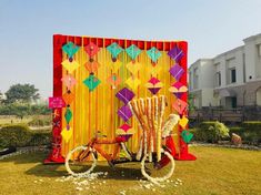 a bike is parked in front of a colorful backdrop with kites on the wall