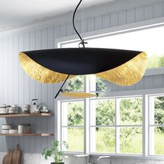 a black and gold chandelier hanging from a kitchen ceiling