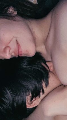 a man and woman are cuddling close together