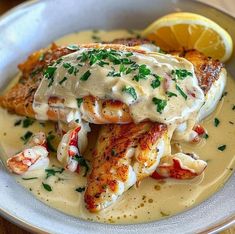 a white plate topped with seafood covered in sauce