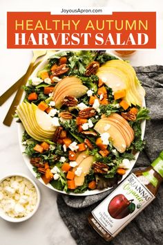 healthy autumn harvest salad with apples, carrots, and feta cheese on top