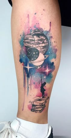 a woman's leg with a watercolor tattoo on it