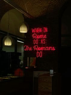 a neon sign that reads, when in rome do as the romans do't