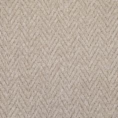 an up close shot of a beige carpet with small, wavy lines on the surface