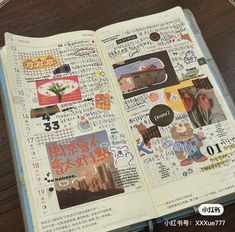 an open book with various stickers and writing on the pages, sitting on a wooden table