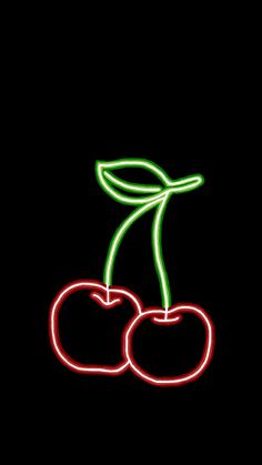 two neon cherries on a black background