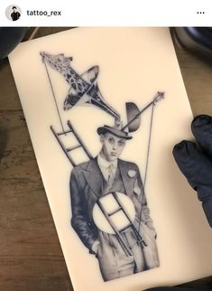 a drawing of a man in a suit and hat holding a kite on top of a piece of paper