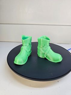 One pair of sturdy cowboy boots for your standing gnome.  These 3-D printed cowboy boots are suitable for gnomes up to approximately 15" tall.  There is a right and left boot.  They are green.  There is a slot inside to insert a dowel, if desired. Approx. measurements: Length = 2 3/4" Width = 1 1/8" Height = 2 3/8" These boots look great and will give your gnome that "finished" look.   They are made of hard plastic PLA filament and can support your standing gnome.   We do custom colors.  Let us Santa Boots, Cow Boy, Doll Parts, Hard Plastic, Custom Color, Cowboy Boots, Cowboy, Bathing Beauties, Electronic Accessories