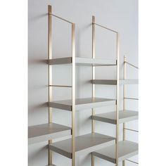 an empty shelf with several shelves on each side and one in the middle, against a white wall