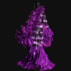 a woman's purple dress is displayed on a mannequin headdress