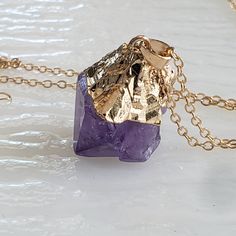 "Comfortable and light enough to wear all day long. On a 16\" brass plated chain, the stone is capped with gold. The stone measures 1\" x .75 It is understood that Amethyst helps improve intuition and provides mental healing. Looking for something longer or shorter? Just leave a note with the desired duration in the seller's comments section. By tapping, please visit all our special jewelry and healing stones Rings. https://www.etsy.com/shop/GlobalJewelryImports Delivered in a free gift box." Spiritual Gold Crystal Necklaces, Purple Necklace With Large Stone For Gift, Gold Mineral Crystal Necklaces With Spiritual Style, Gold Crystal Necklace With Natural Stones, Gold Mineral Crystal Spiritual Necklace, Purple Spiritual Necklace With Large Pendant, Gold Spiritual Mineral Crystal Necklace, Gold Amethyst Jewelry With Adjustable Chain, Spiritual Purple Necklace With Large Pendant