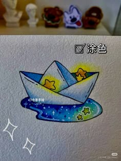 an origami boat floating in the water with stars and moon on it's side