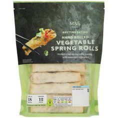 an image of vegetable spring rolls packaged in plastic wrapper on white backgroung