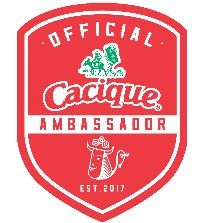 the official cacique ambassador logo on a red shield with white lettering and an image of a horse