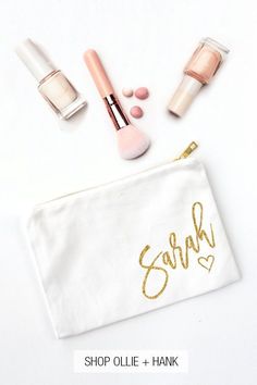 the contents of a personal makeup bag on a white background with gold lettering and cosmetics