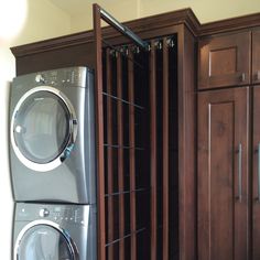 a washer and dryer sitting next to each other in front of wooden cabinets