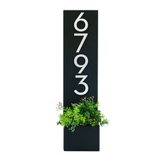 a black sign with white numbers and plants in the bottom right corner, on a white background