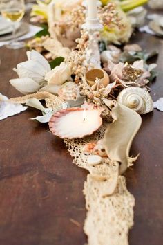 a close up of a table with flowers and candles on it's side,