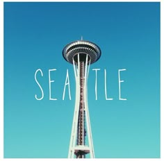 the seattle space needle in front of a blue sky with words that read seattle on it