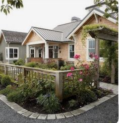 a house with flowers and plants around it