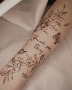 a woman's arm with flowers and butterflies on it, which says i love you every day