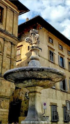 a fountain in front of an old building