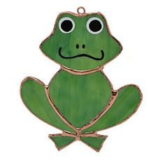 a green frog ornament with black eyes