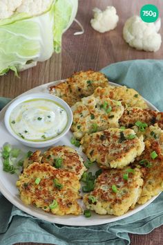 some food on a white plate with sauce and lettuce next to it,