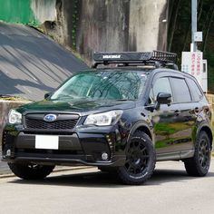 a black subarunt is parked on the street